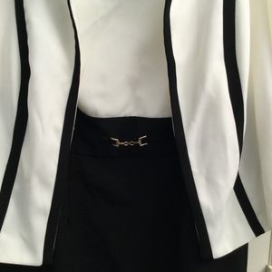 Black and white dress and jacket with gold buckle.